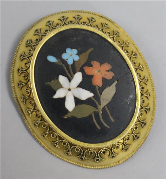 A gilt metal mounted pietra dura oval brooch with floral decoration, 46mm.